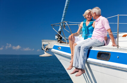 Elderly couple sitting on the bow of a boat